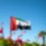 The UAE national flag waving proudly against a clear blue sky